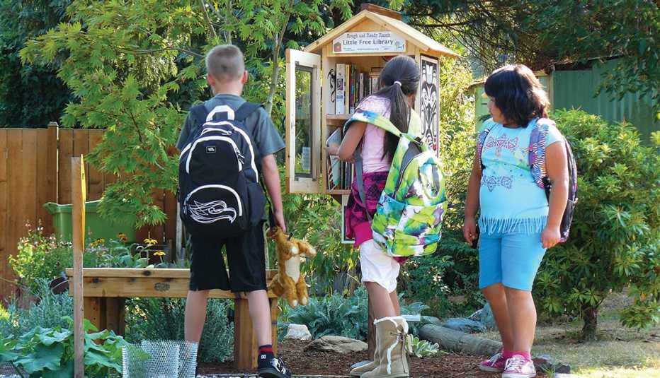 Three children visit a Little Library in Mountainlake Terrace, Washington
