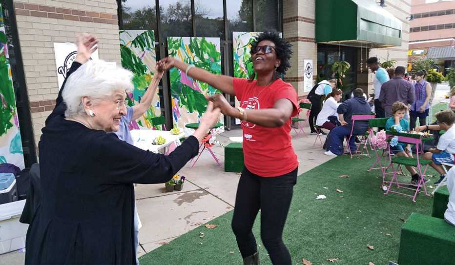 Two women dance at a block party in Washington DC