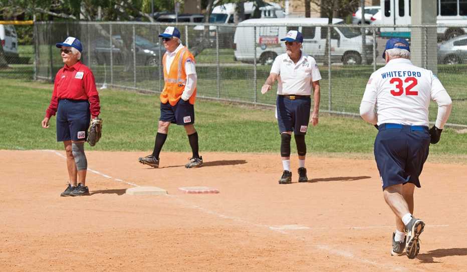Four Kids and Kubs softball club teammates (including one woman) 