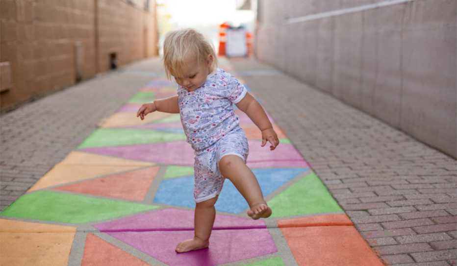 Toddler plays in revitalized alley in Oconomowoc, Wisconsin