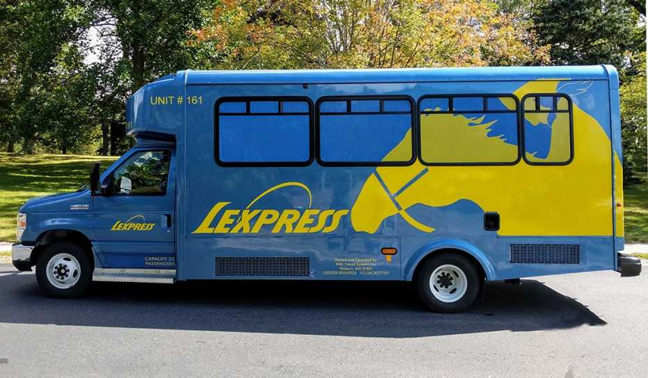 A blue and yellow Lexpress shuttle bus in Lexington, Massachusetts