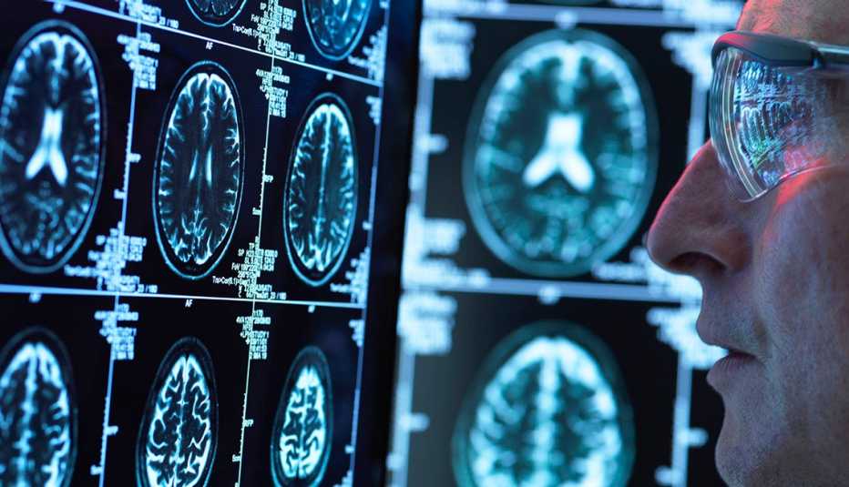 researcher looks at brain scans