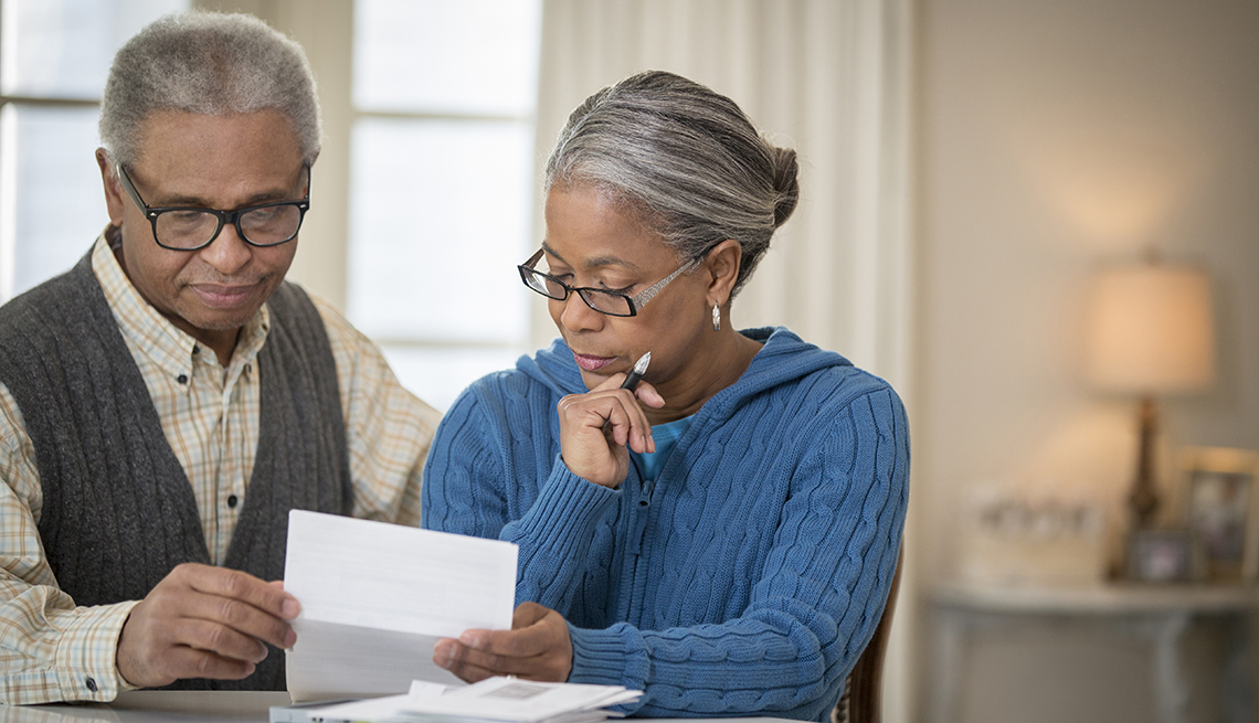 older couple paying bills