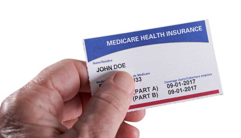 close up of a hand holding a medicare health insurance card