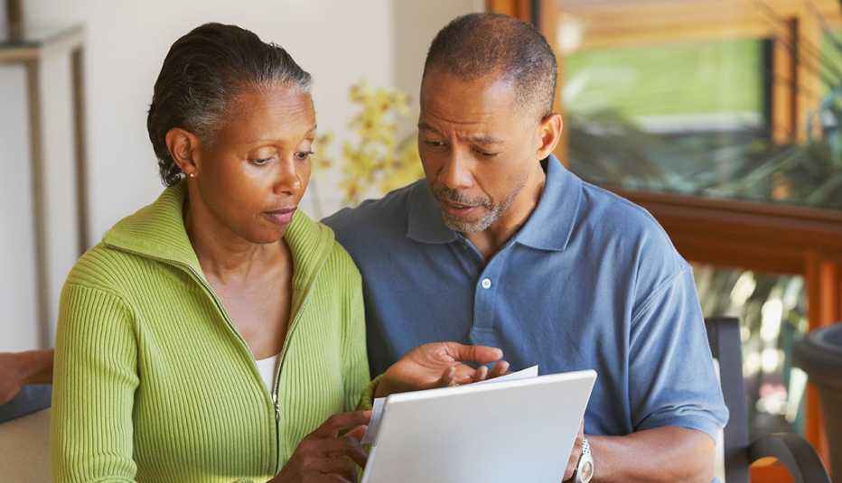 couple seated paying their bills