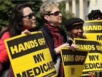Protesters against cutting Medicare hold signs that read, hands off my medicare. Protesters against cutting Medicare hold signs that read, hands off my medicare.