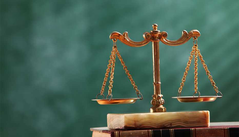 balance scale in front of a green background