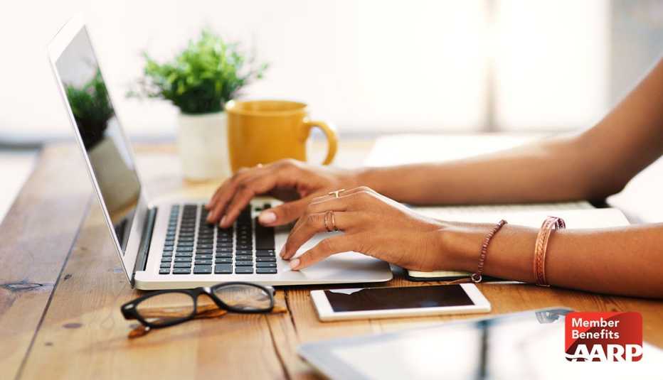 Woman learning about AARP technology benefits on laptop