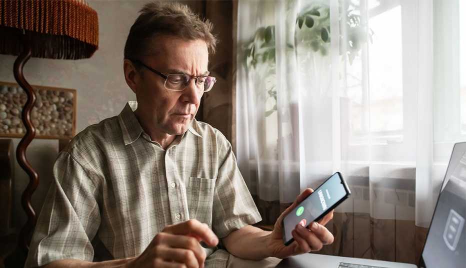 AARP member getting call from unknown number while working on computer