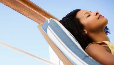 woman eyes closed on deck chair woman eyes closed on deck chair