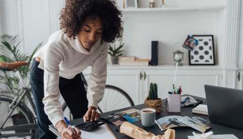 woman standing writing at desk woman standing writing at desk