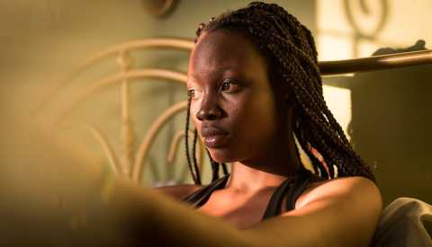 Woman sitting in room alone Woman sitting in room alone