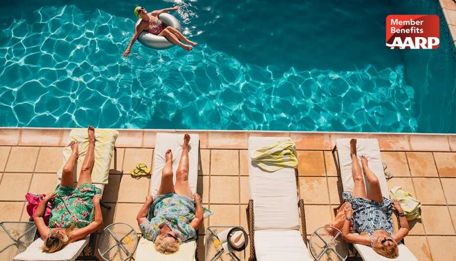 Group of ladies on vacation enjoying lounging by pool on a sunny summer day thanks to their AARP travel benefits
