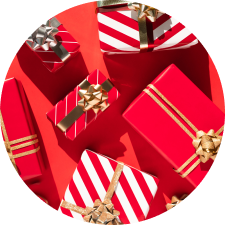 Holiday gifts wrapped in red wrapping baper with gold bows