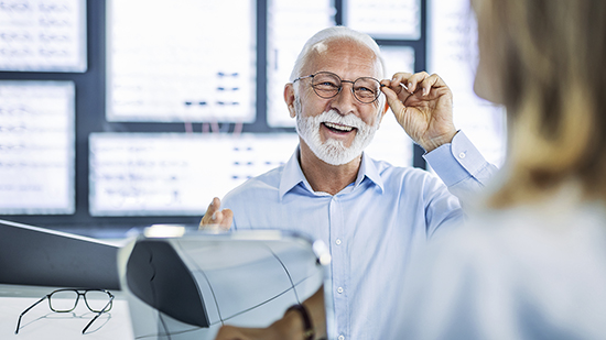 Senior man examining eyes at ophthalmologist