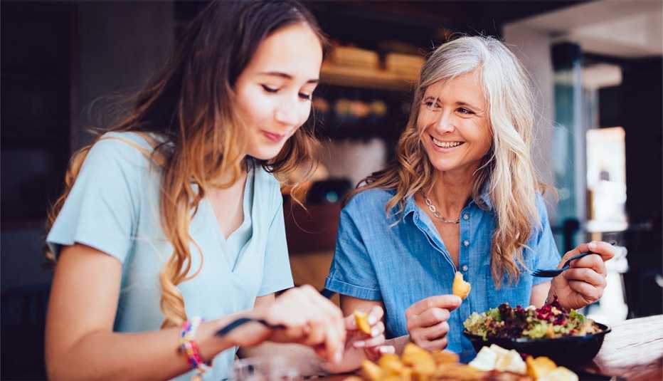 Two women dining at a restaurant and smiling