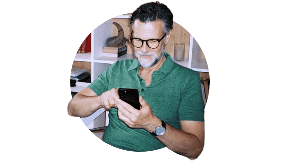 AARP member checking updates from his Yahoo Finance Premium Plan on his smartphone