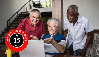Daily Rewards Points three older men in front of a computer looking at it and smiling in a living room of a home