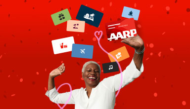 Celebrate Your Rewards woman standing with arms up and smile on face celebrating, red background, gift cards and the A A R P membership card floating above her