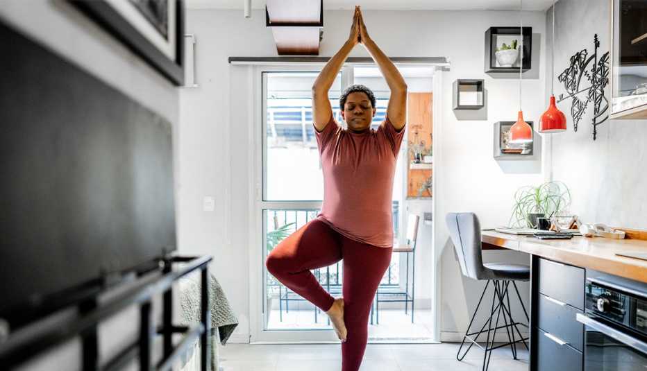 Woman doing yoga in her kitchen