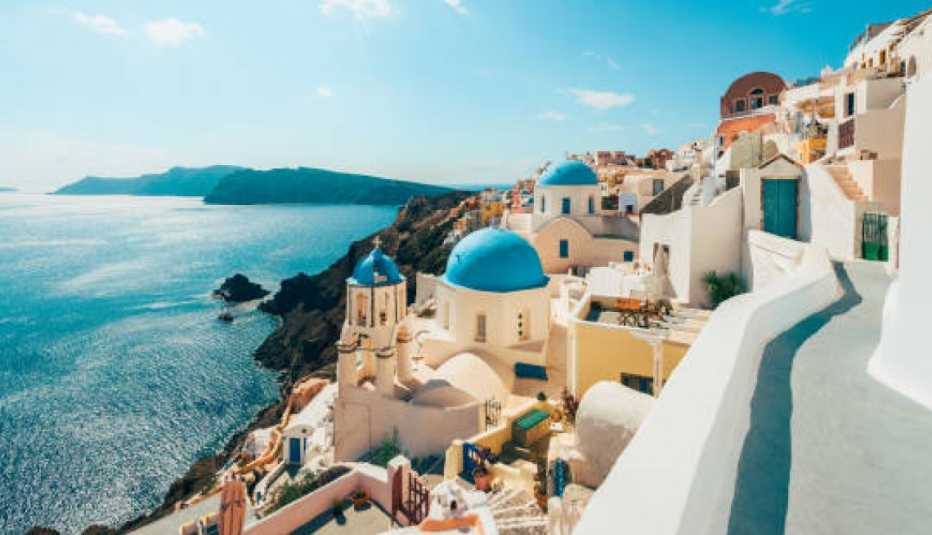white and blue buildings overlooking the sea in santorini, greece 