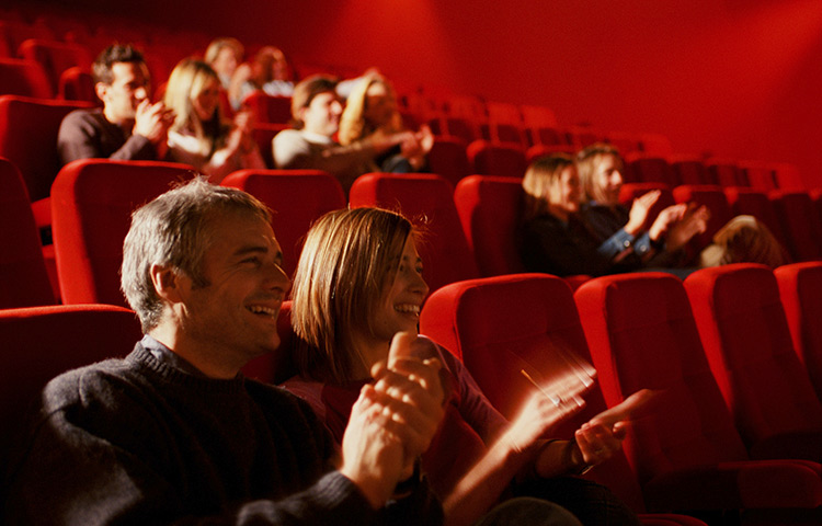 Picture of an audience clapping in a movie theater