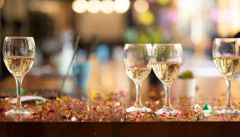 wine glasses with white wine in them on table