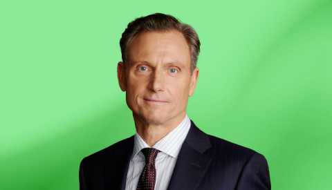Tony Goldwyn against green ombre background