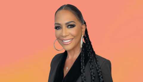 Sheila E against pinkish orange background