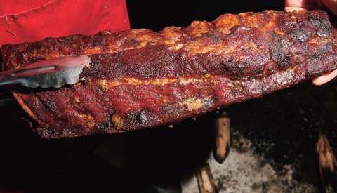 tongs holding long thing of ribs