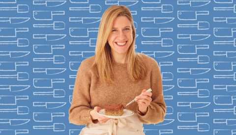 lidey heuck holding piece of cake on plate; blue background with outlines of kitchen utensils on it
