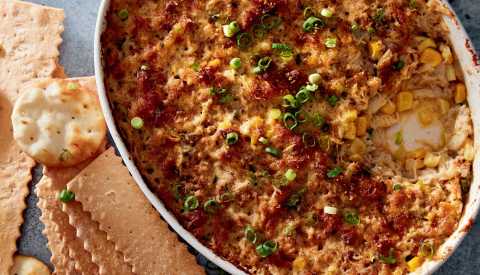 crab dip in dish with crackers on side