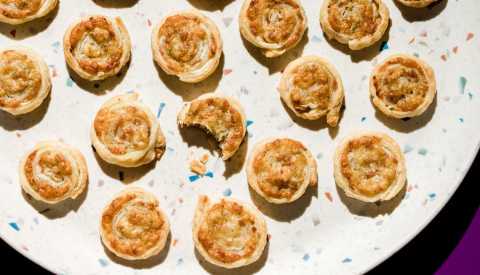 round puff pastries on a dish stuffed with cheese and meat