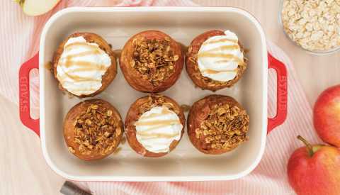 baked apples with oat crumble on all and fluffy white topping on half