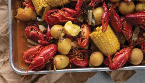 corn, crawfish and yellow potatoes in pan