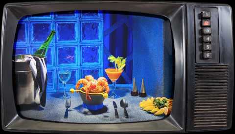 vintage television border around a table setting with cocktail-style shrimp and orzo dish, glass of bloody 'tini, plate of lemon slices, glass of white wine and bottle of wine in ice bucket