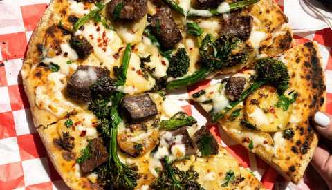 pizza with pot roast, potatoes and broccolini on it