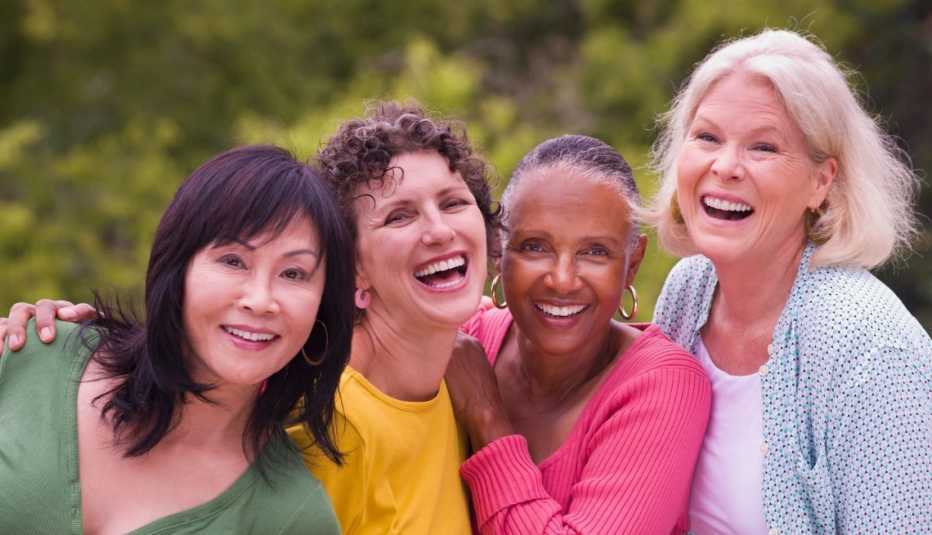 a happy aarp member and her friends in the refer a friend program