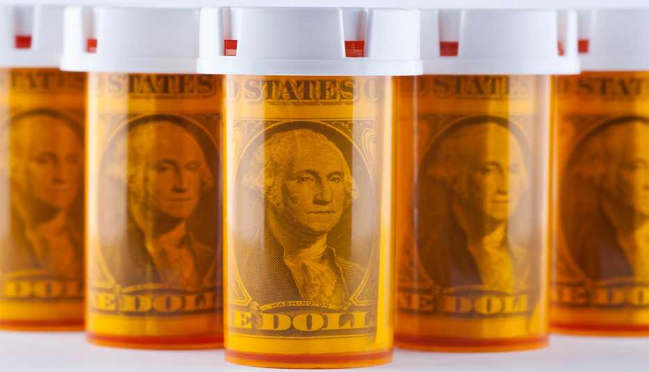 Translucent yellow prescription pill bottles filled with dollar bills.