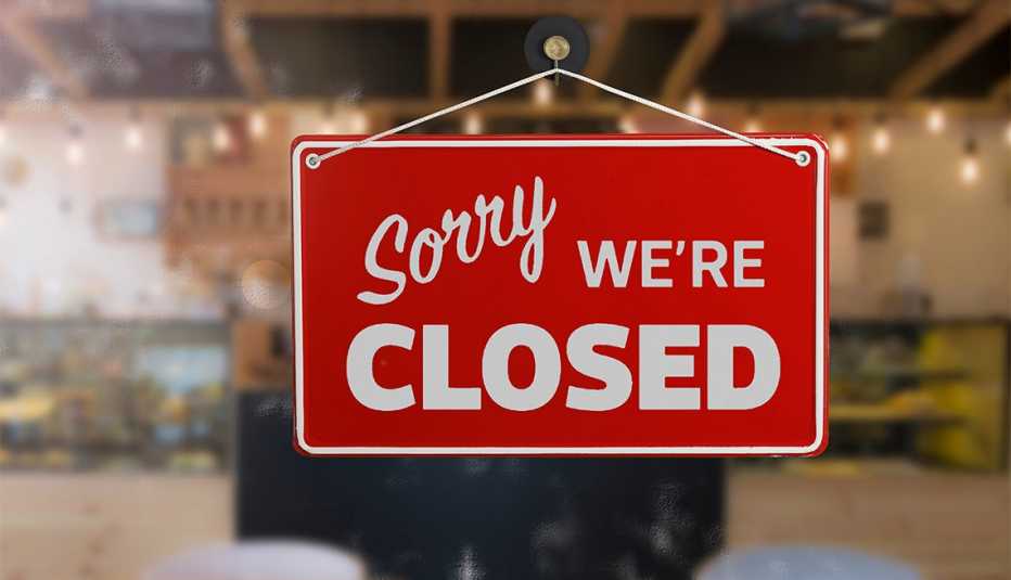 red and white closed sign on a storefront window