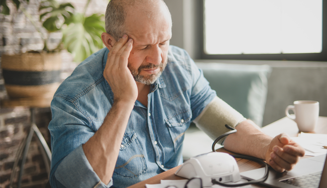 worried man taking his blood pressure