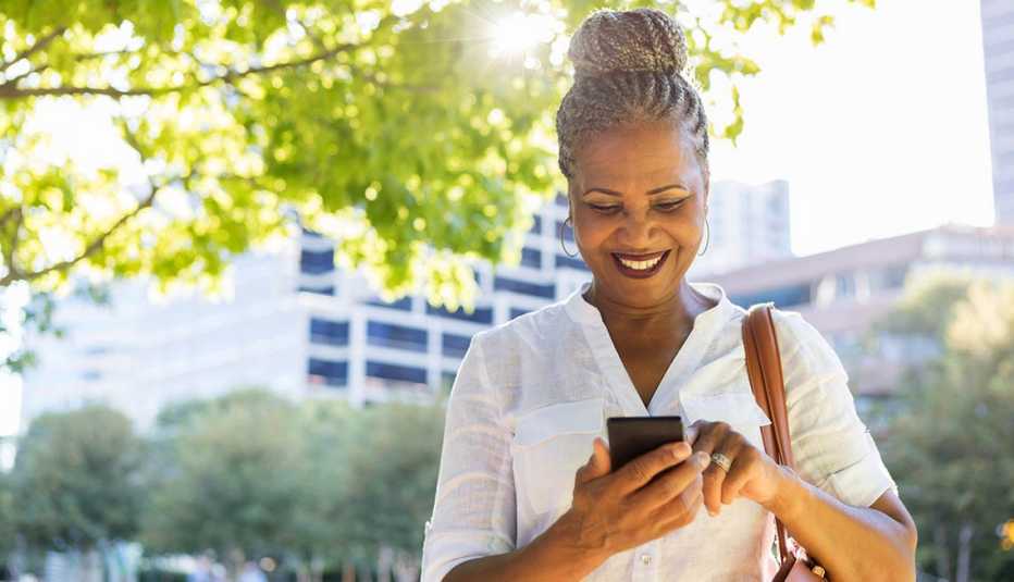 woman looks at smartphone