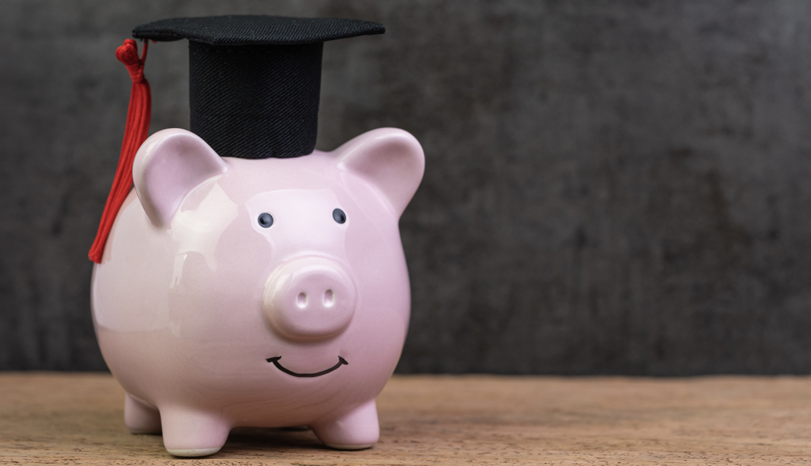 a piggy bank wearing a graduation cap