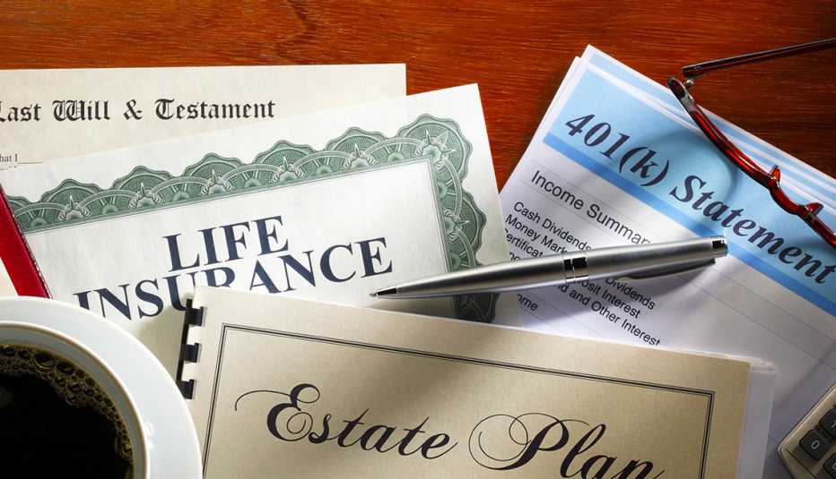 A desk top with with many of the documents relating to estate planning, including a 401K statement, a life insurance policy and last will and testament.