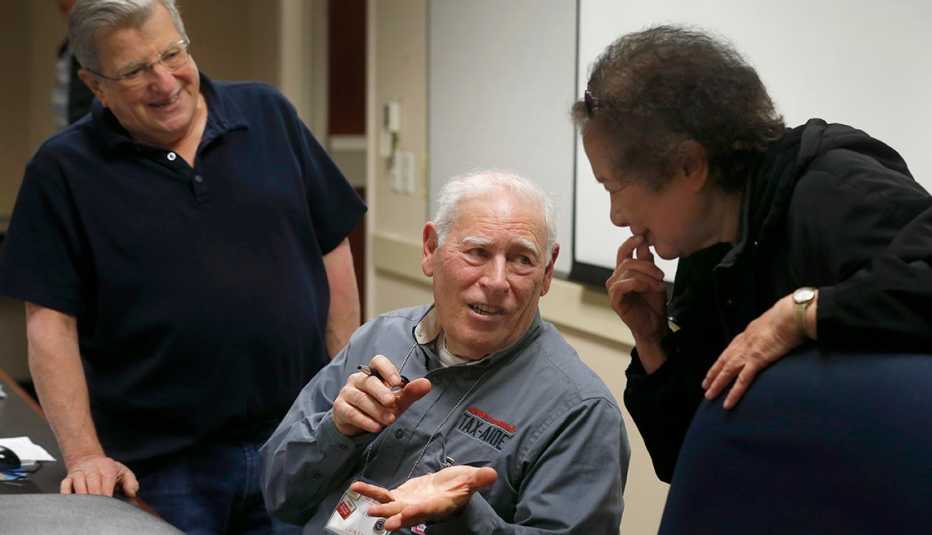 Hal Helfand answers questions from Max Cline (left) and Marilyn Wong during a two-day seminar in Oakland, Calif. on Wednesday, Jan. 23, 2019 to train tax preparers who will be volunteering their services for the AARP Foundation Tax-Aide program. 