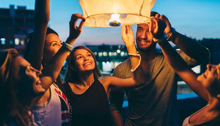 Group of five people holding a paper lantern during a memorial service