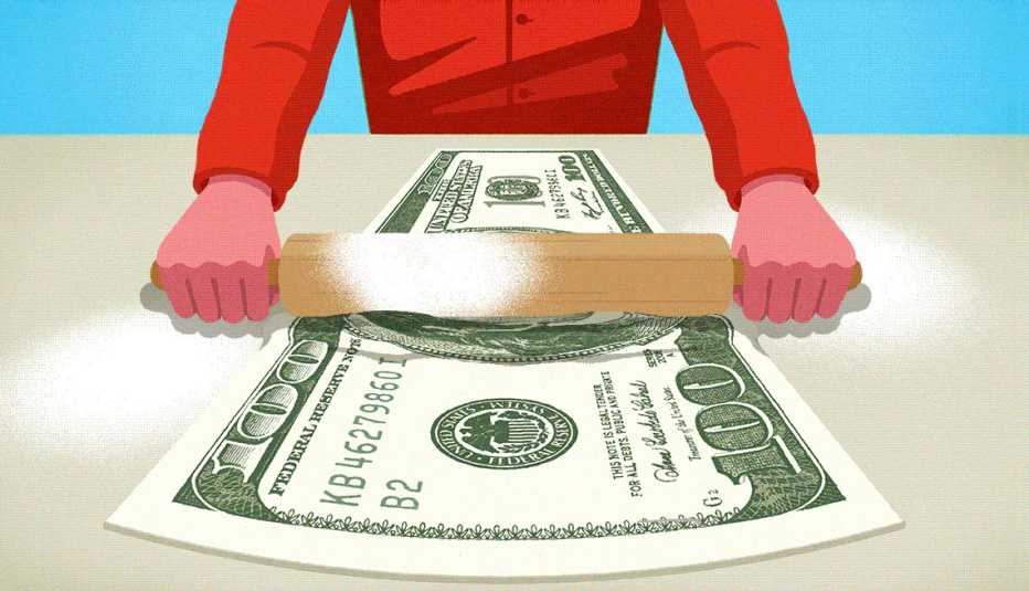 a person is using a rolling pin over money