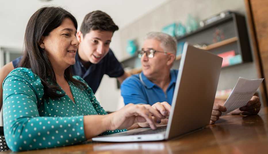 A pleasant family discussion involving information on a laptop and financial papers.