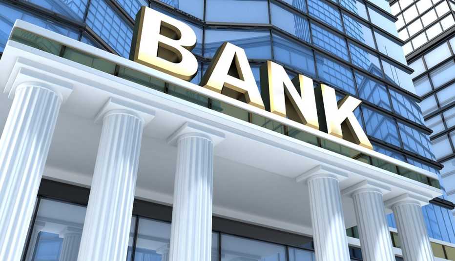 The exterior of a white pillared entrance of a generic bank building