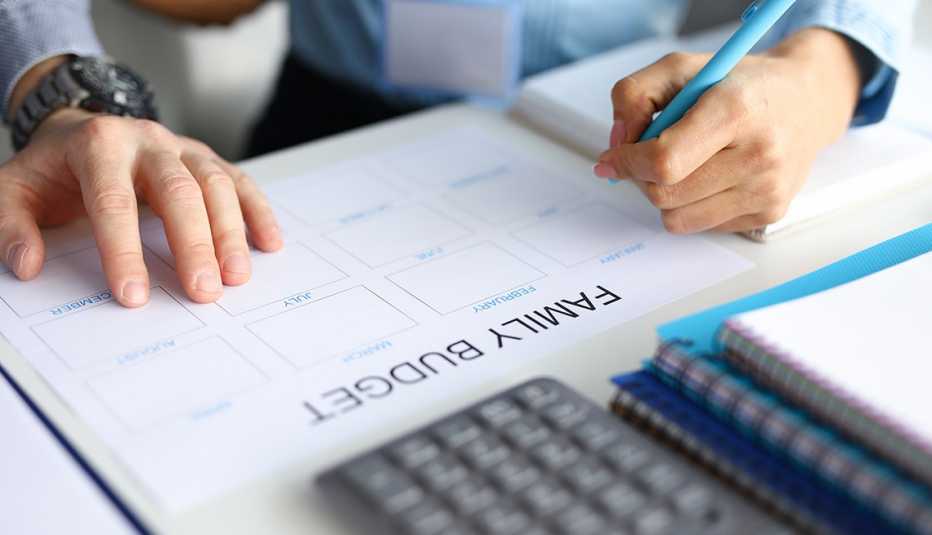 Close-up of a couple working on their monthly family budget plan
